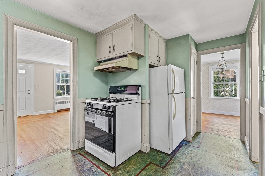 7 Spring Street Lexington, MA 02421 - Photo 10 of 25 a kitchen with stainless steel appliances granite countertop a refrigerator and a stove