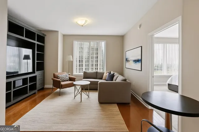 a living room with furniture and a flat screen tv