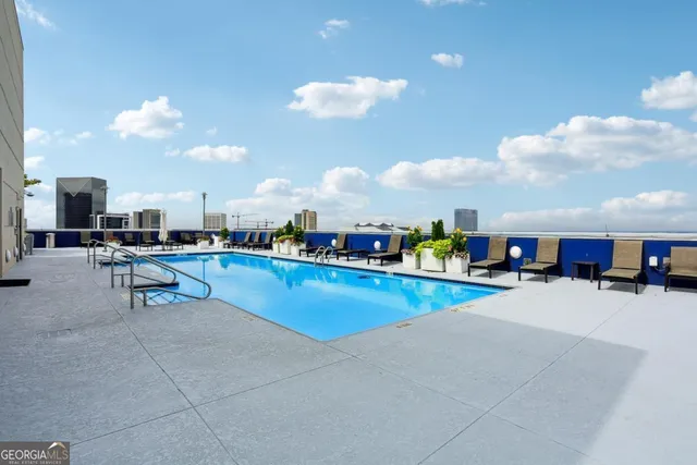 a swimming pool with outdoor seating