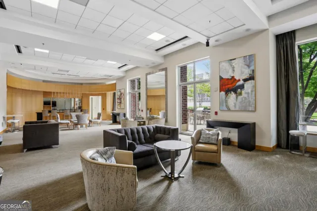 a living room with fireplace furniture and a large window