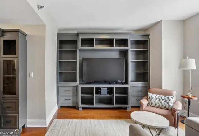 a living room with furniture and a bookshelf