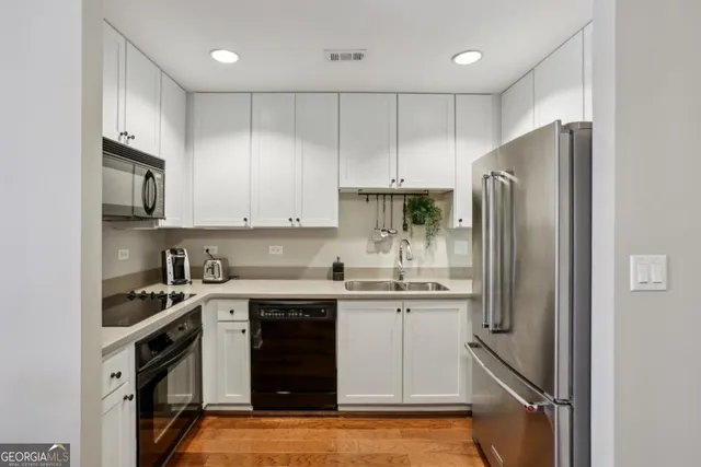 a kitchen with stainless steel appliances granite countertop a refrigerator sink and cabinets