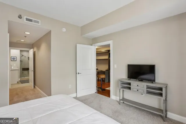 a view of a livingroom with furniture and flat screen tv