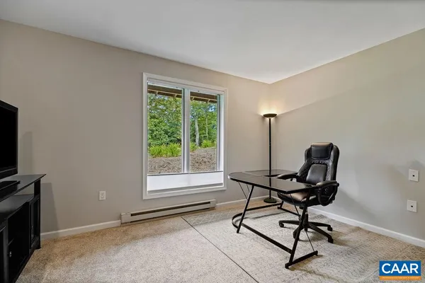 a living room with furniture and flat screen tv