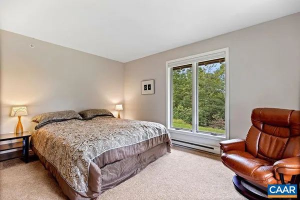 a bed sitting in a bedroom next to a window