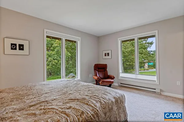 a bedroom with a bed and flat screen tv