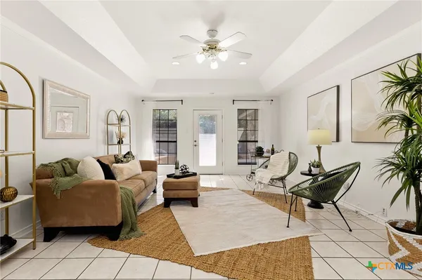 a living room with furniture and wooden floor