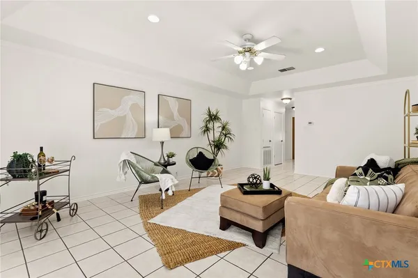 a living room with furniture and white walls