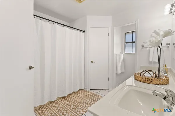 a bedroom with a bed and a curtain