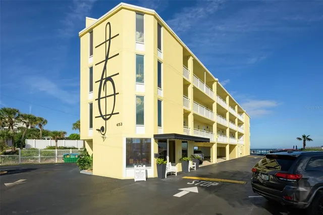 a view of a building with car parked