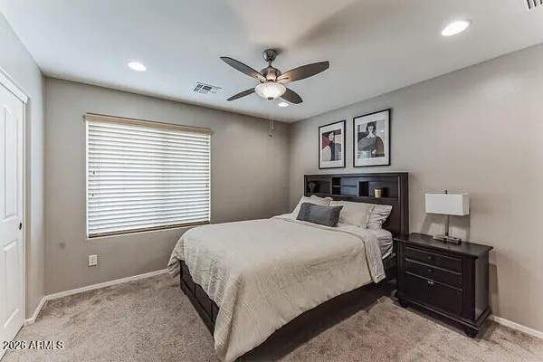 a bedroom with a bed and a window