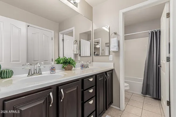 a kitchen with kitchen island granite countertop wooden cabinets and refrigerator