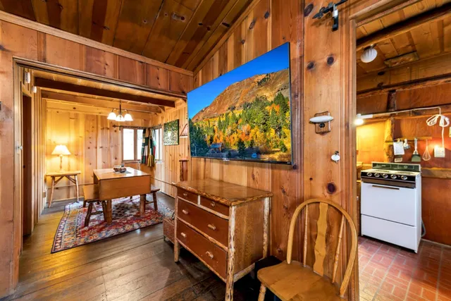 a very nice looking room with wooden floor and furniture