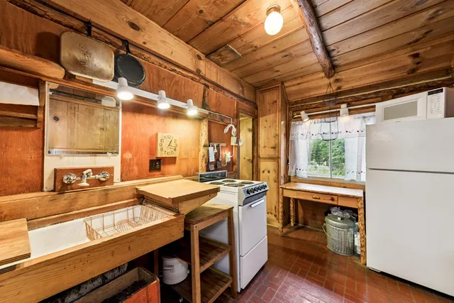 a kitchen with a stove a sink and a refrigerator