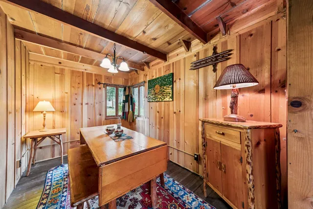 a dining room with furniture and wooden floor