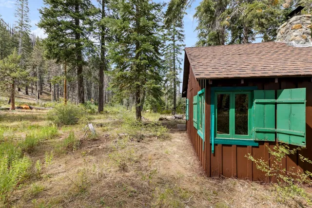 a view of a wooden house with a yard