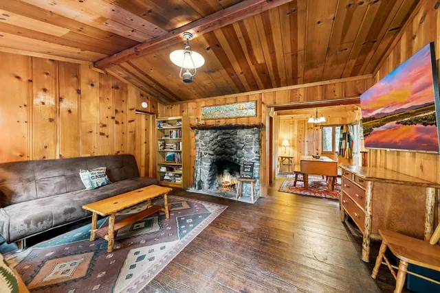 a living room with furniture a wooden floor and next to a window