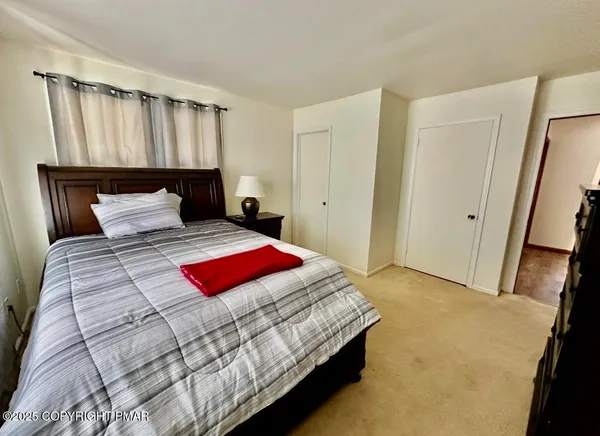 a bedroom with a bed and a mirror