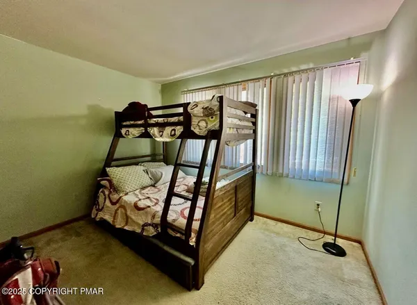 a bedroom with bunk beds and a mirror