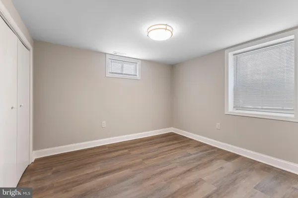a view of a room with wooden floor and windows