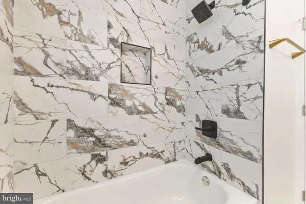 a bathroom with a bathtub and shower