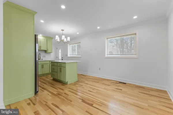 an empty room with a kitchen and a sink