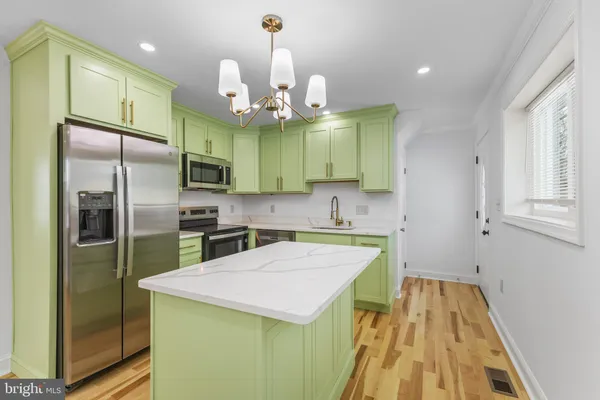 a kitchen with a refrigerator a sink and dishwasher