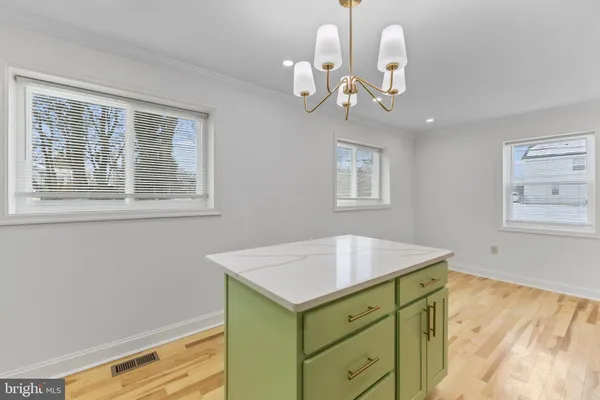 a bathroom with a sink a chandelier and a mirror