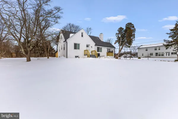 a view of the house with a snow in the yard