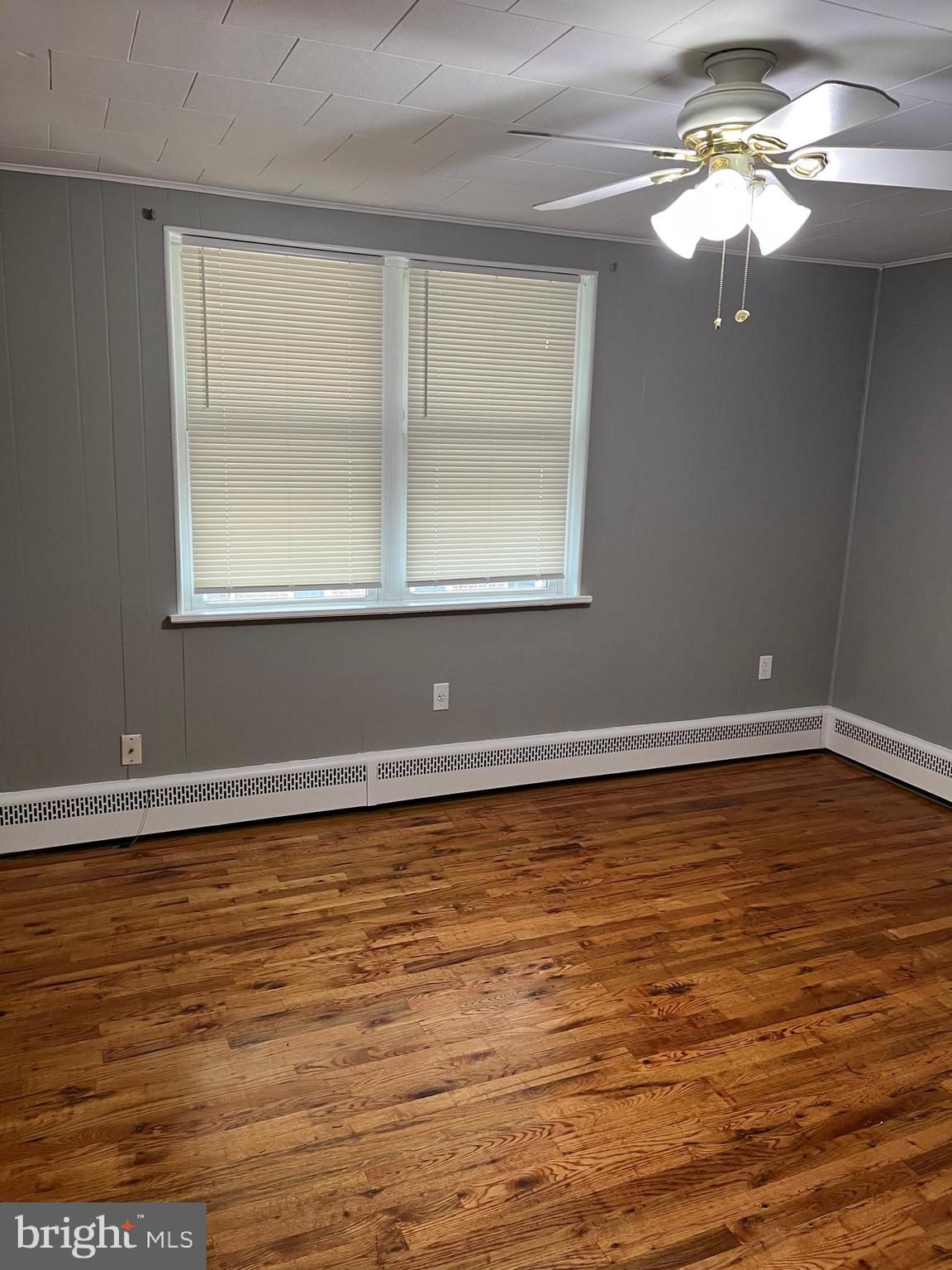 4329 Dungan Street Philadelphia, PA 19124 - Photo 3 of 13 a view of a room with a ceiling fan and wooden floor