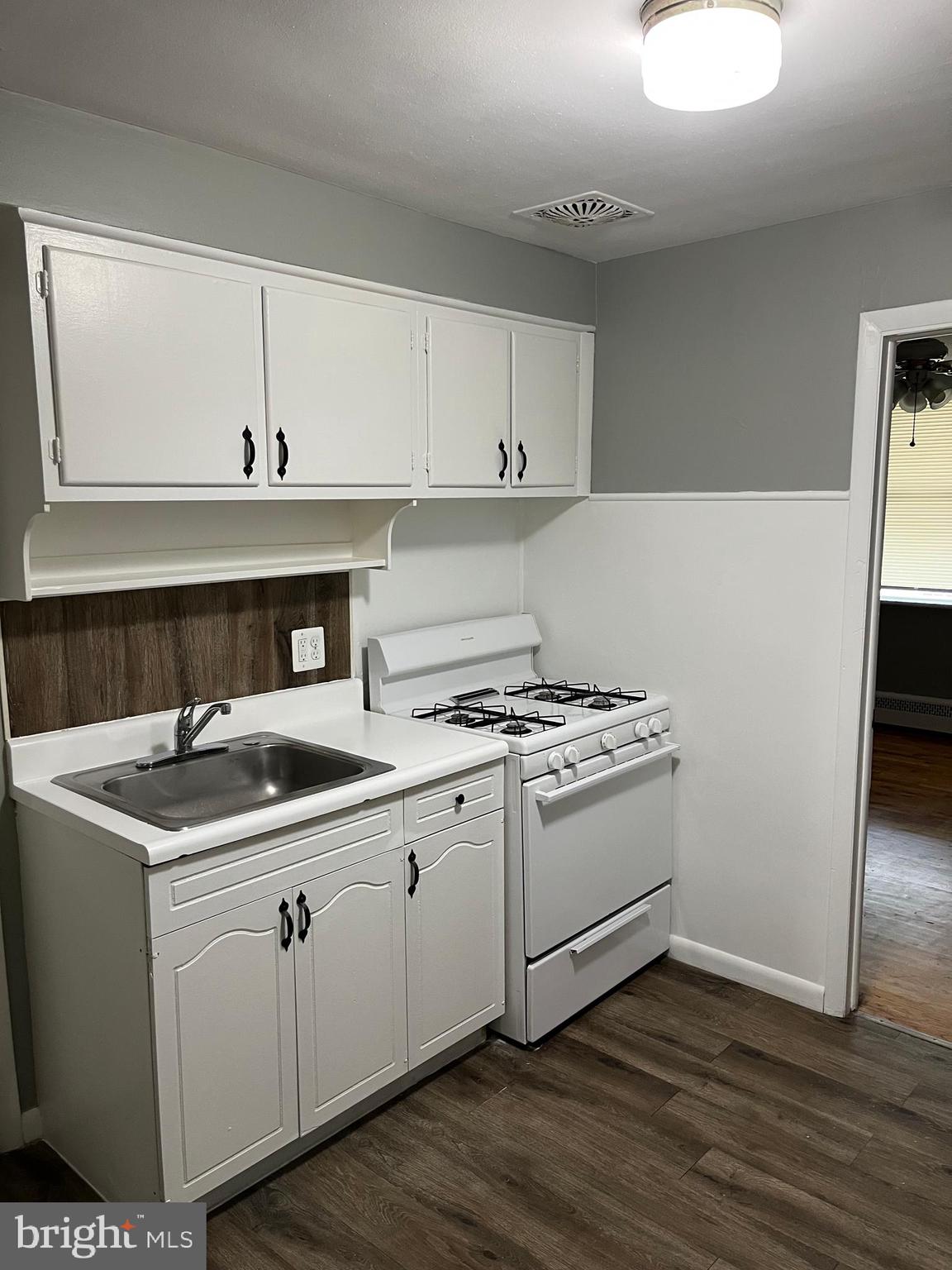 4329 Dungan Street Philadelphia, PA 19124 - Photo 6 of 13 a kitchen with a sink cabinets and wooden floor