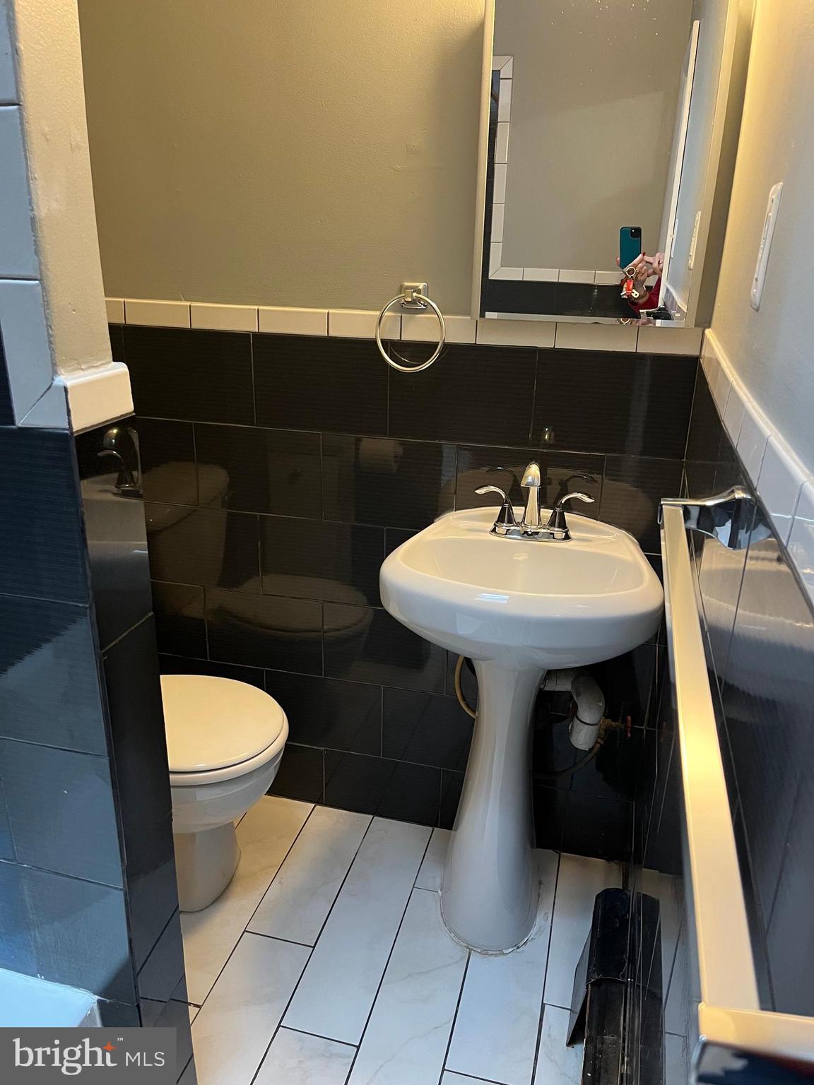 4329 Dungan Street Philadelphia, PA 19124 - Photo 9 of 13 a bathroom with a sink toilet and mirror