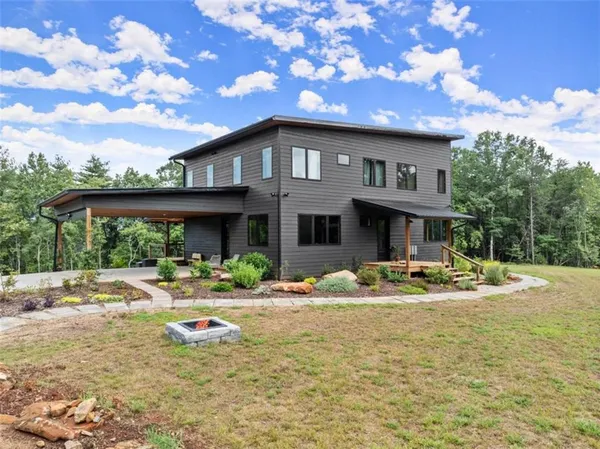 a front view of a house with swimming pool and porch