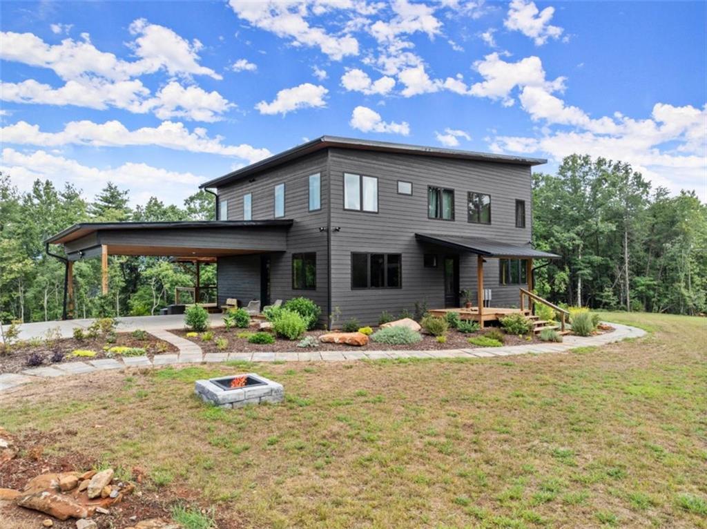 a front view of a house with swimming pool and porch