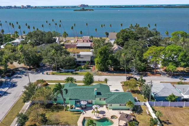 an aerial view of a house with yard swimming pool and outdoor seating