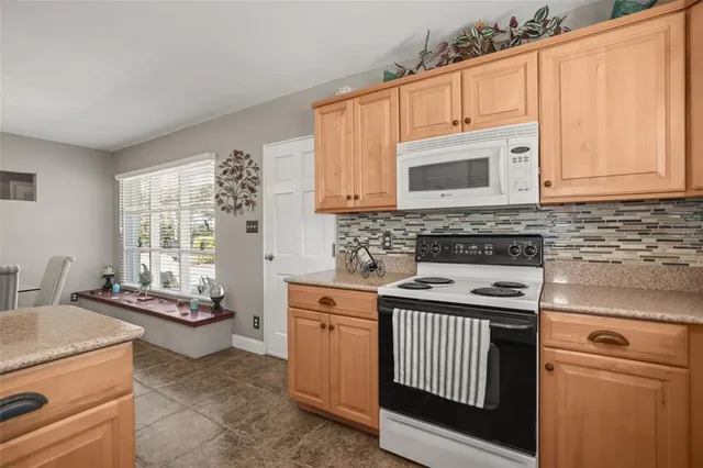 a view of a livingroom with a fireplace and window