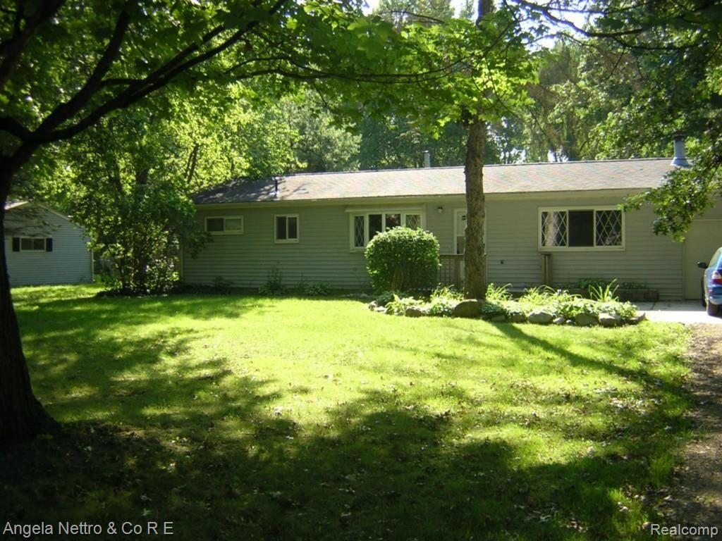 19700 Karr Road Belleville, MI 48111 - Photo 1 of 23 FRONT OF HOME WITH TREED SETTING
