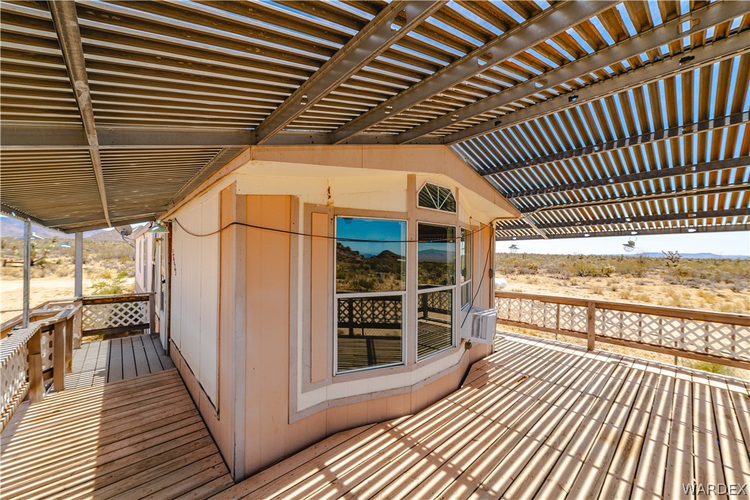 16435 South Wyatt Earp Road Yucca, AZ 86438 - Photo 18 of 57 Expansive outdoor deck area featuring wood-finish flooring and a slatted metal patio cover