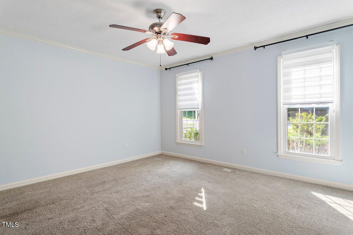 8337 Greywinds Drive Raleigh, NC 27615 - Photo 20 of 27 an empty room with windows and fan