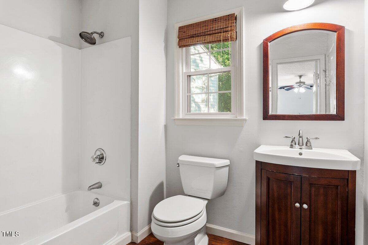 8337 Greywinds Drive Raleigh, NC 27615 - Photo 23 of 27 a bathroom with a toilet a sink and bathtub