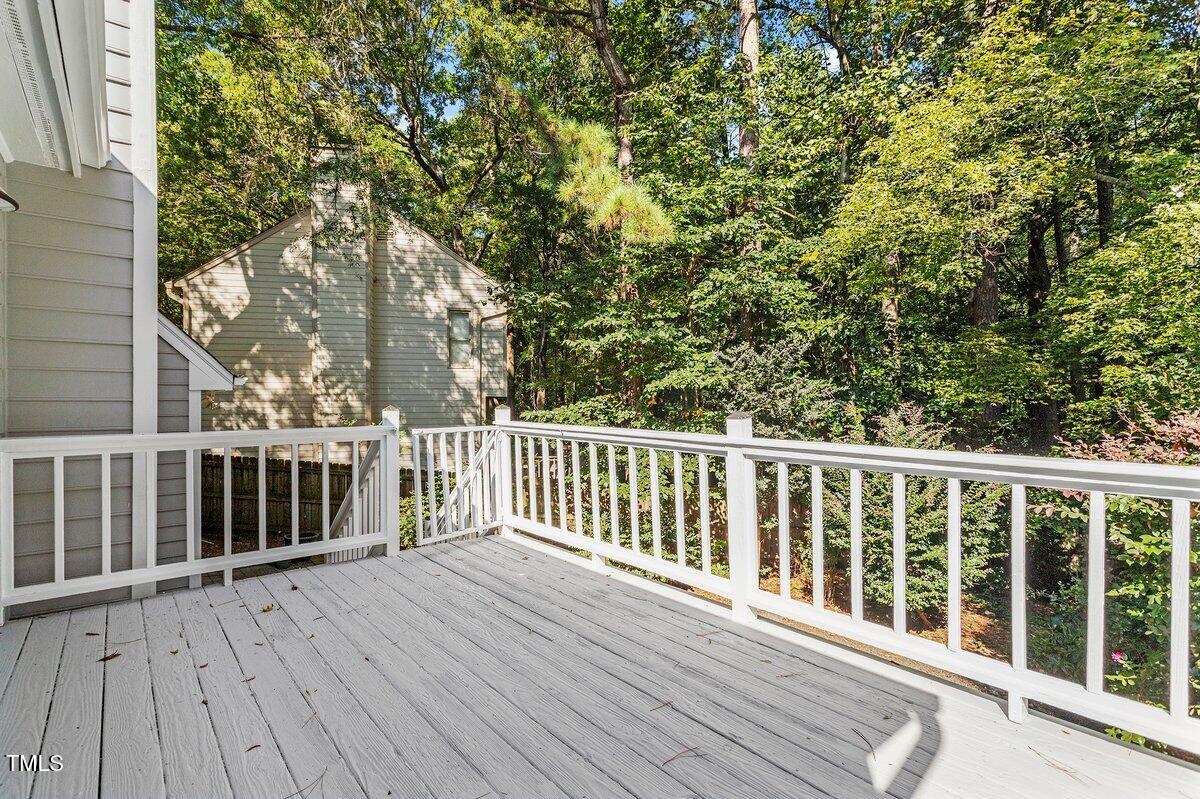 8337 Greywinds Drive Raleigh, NC 27615 - Photo 25 of 27 a balcony with wooden floor and fence
