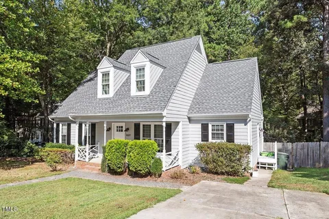 a front view of a house with a yard outdoor seating and garage