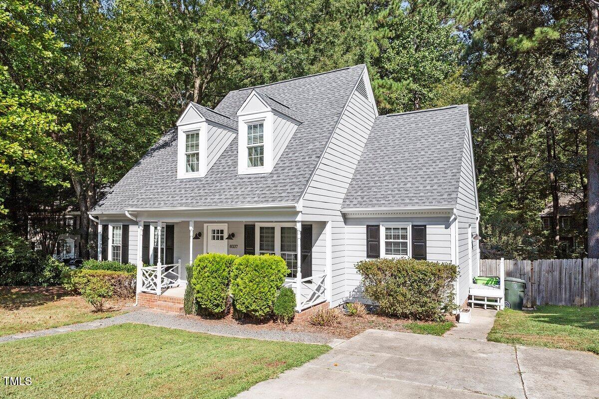 8337 Greywinds Drive Raleigh, NC 27615 - Photo 3 of 27 a front view of a house with a yard outdoor seating and garage