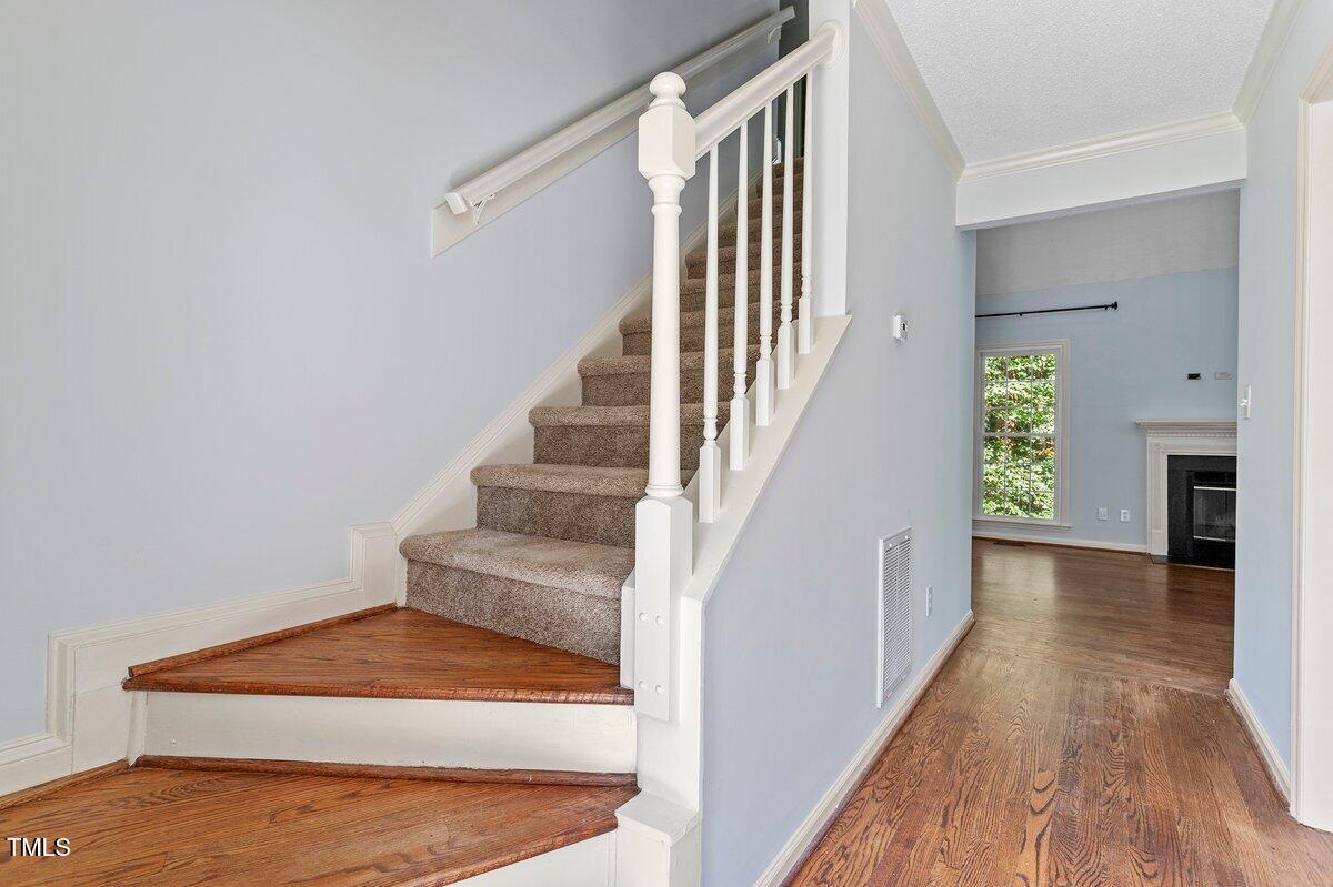8337 Greywinds Drive Raleigh, NC 27615 - Photo 6 of 27 a view of entryway and hall with wooden floor