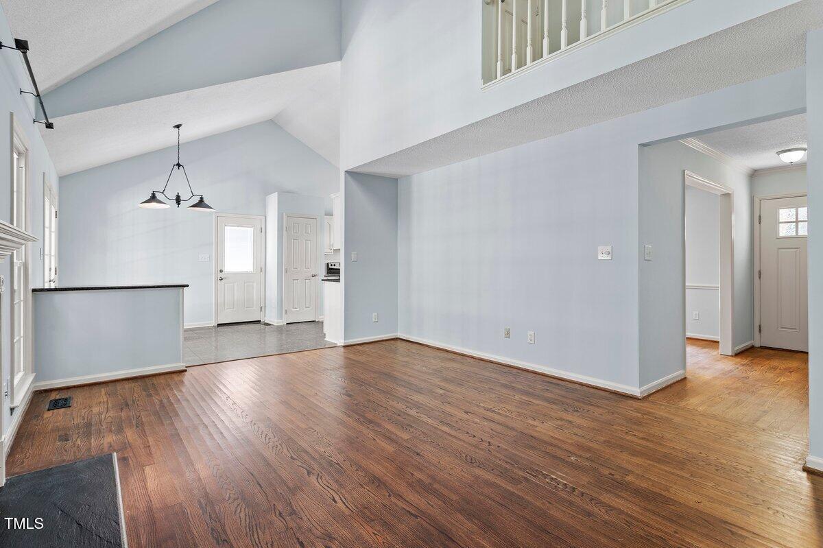 8337 Greywinds Drive Raleigh, NC 27615 - Photo 8 of 27 a view of empty room with wooden floor and window