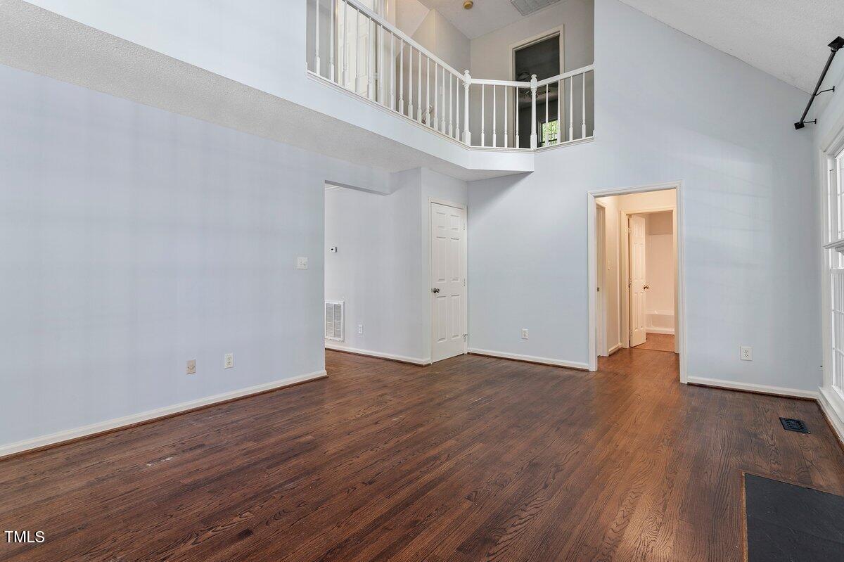 8337 Greywinds Drive Raleigh, NC 27615 - Photo 9 of 27 wooden floor in an empty room