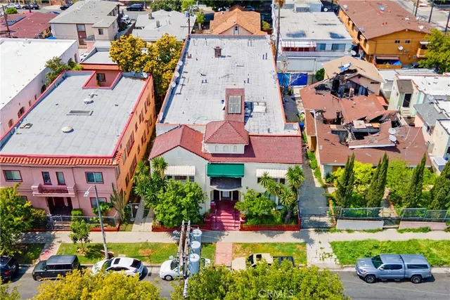 an aerial view of a houses with yard and swimming pool