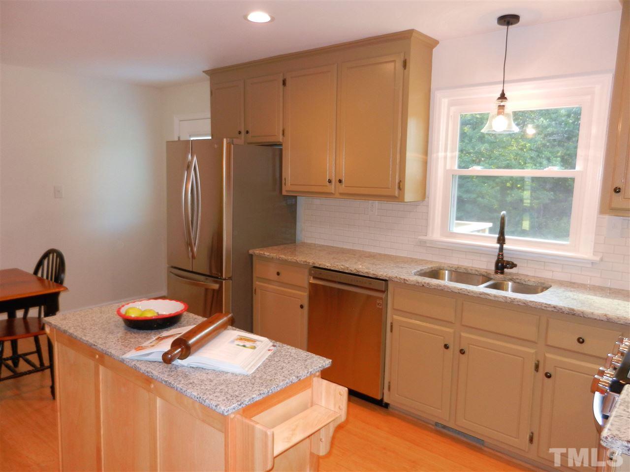 11916 Us 64 A Spring Spring Hope, NC 27882 - Photo 8 of 25 a kitchen with stainless steel appliances granite countertop a sink dishwasher and a refrigerator with wooden cabinets