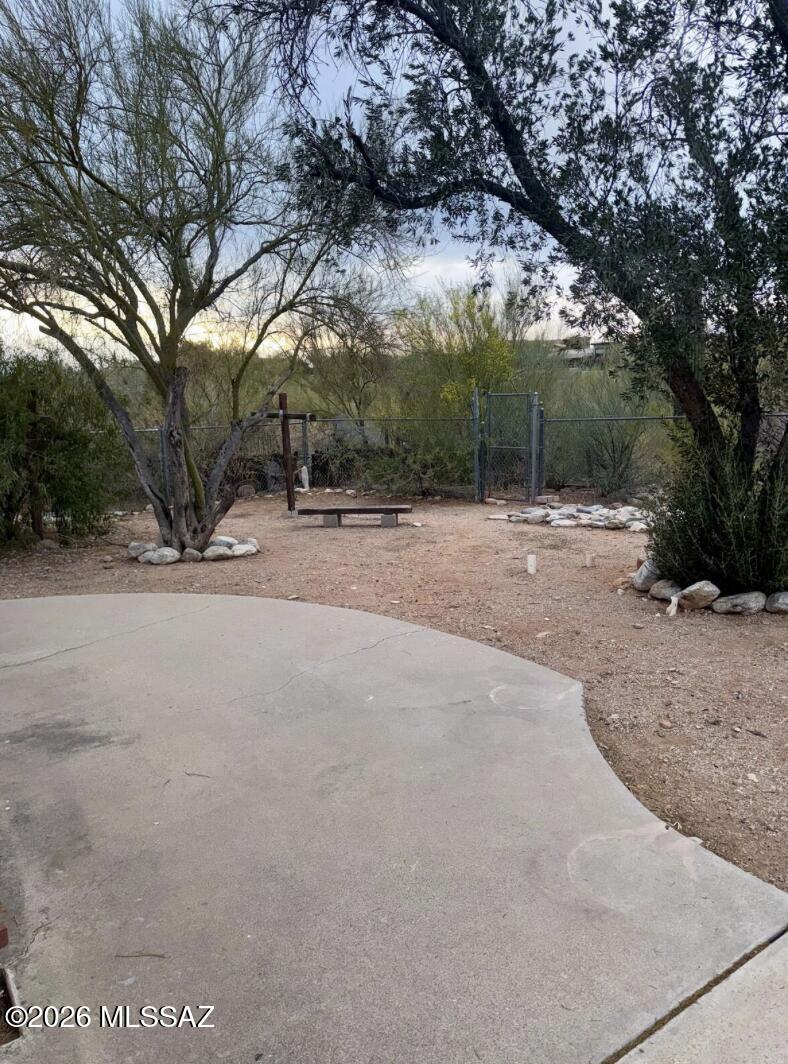 4415 North Swan Road Tucson, AZ 85718 - Photo 23 of 33 a backyard of a house with large trees and outdoor seating