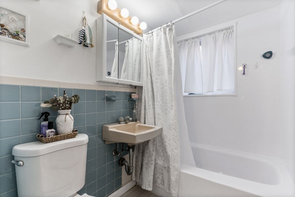 16 Bryon Road, Unit 2 Boston, MA 02467 - Photo 8 of 12 a bathroom with a sink a toilet and bathtub